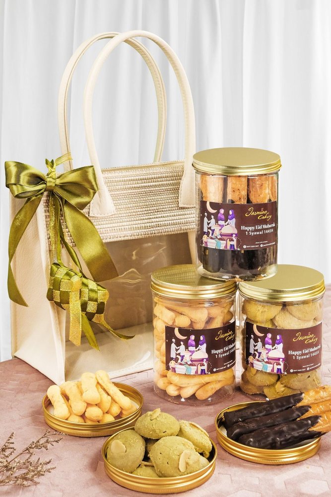 Gift bag of snack jars tied with a gold ribbon