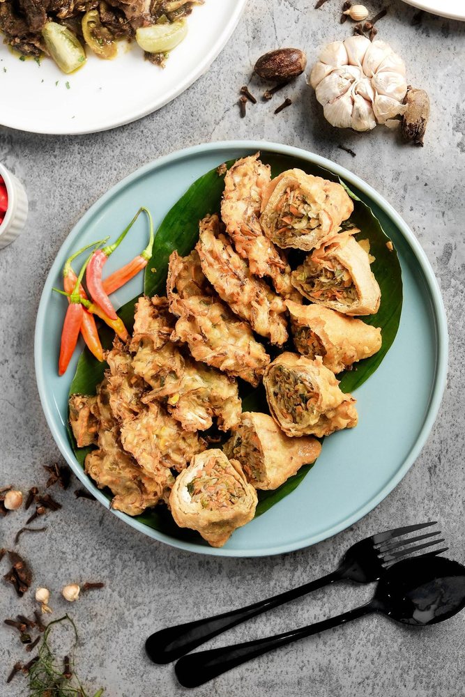 Fried chicken plated with fresh garnish